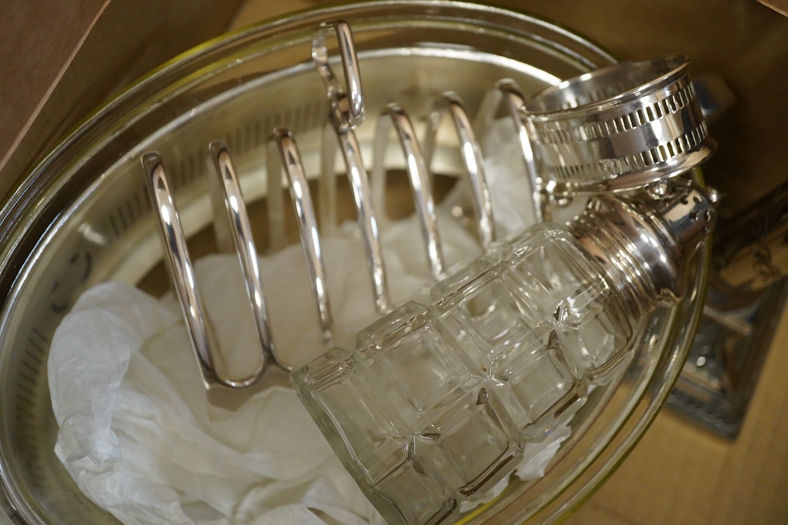 Assorted plated wares including a pair of candlesticks and a casserole dish.